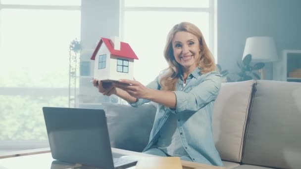 Весела приємна щаслива леді насолоджується переїздом пропозиції провести паперовий будинок — стокове відео