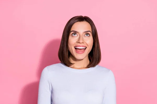 Foto de adorable mujer joven impresionada usar suéter blanco buscando espacio vacío sonriendo aislado color rosa fondo —  Fotos de Stock