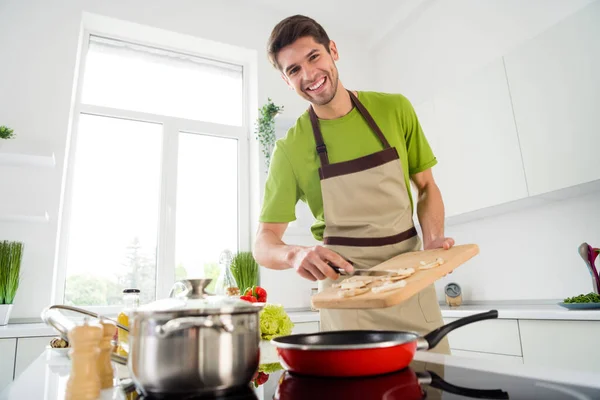 魅力的な陽気な男の肖像料理おいしいおいしいおいしい健康的な食事軽い白いキッチンの家で食材をフライパン屋内 — ストック写真