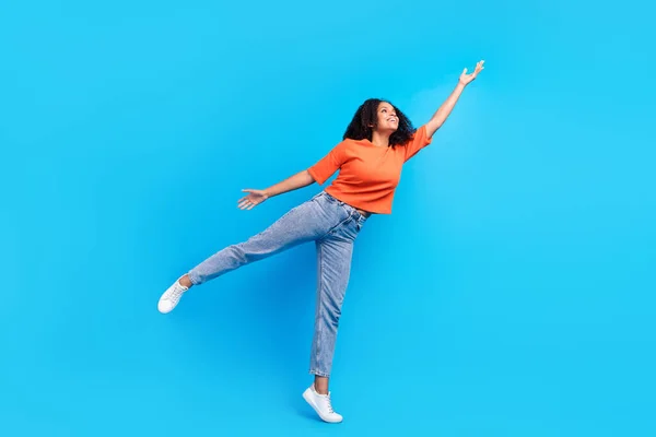 Full length photo of dreamy happy joyful afro american young woman hand empty space isolated on blue color background — Stock Photo, Image