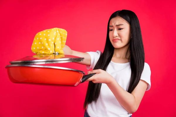 Foto van verdachte walgelijke Chinese dame houden pan bedorven friet slijtage handschoen wit t-shirt geïsoleerde rode kleur achtergrond — Stockfoto