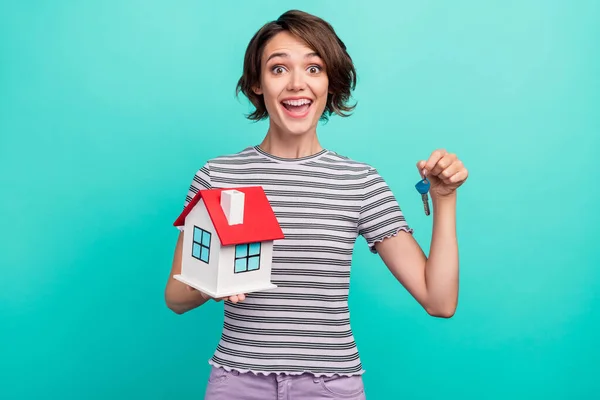 Photo of young excited girl happy positive smile home key ownership mortgage isolated over teal color background.