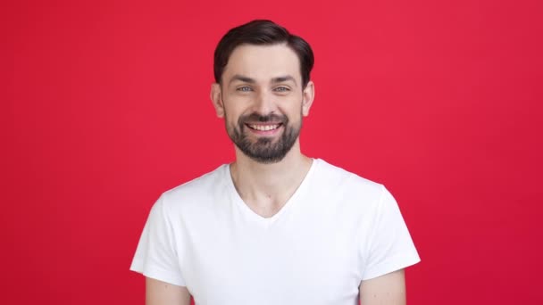 Mann genießen Gel-Look im Spiegelgesicht zahmes Lächeln isoliert rote Farbe Hintergrund — Stockvideo
