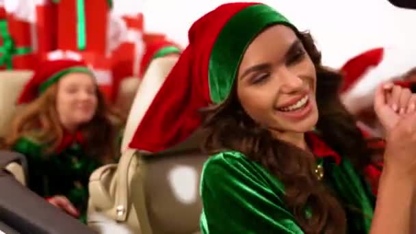 Positive carefree elf santa friends ride cabriolet deliver presents — Stock Video