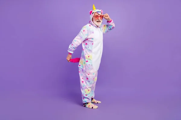 Photo of funky excited retired man nightwear overall hand arm dark eyewear smiling isolated purple color background — Zdjęcie stockowe
