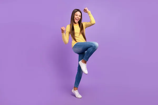 Full body photo of youth excited girl celebrate lucky victory fists hands triumph isolated over violet color background