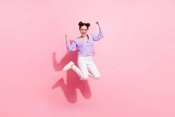 Фотографія повного розміру тіла веселої дівчини, що стрибає з високим недбалим жестом, як переможець, ізольована на пастельному рожевому кольоровому фоні — стокове фото