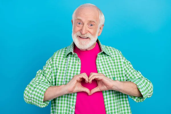 Photo de vieux joyeux homme heureux tenir la main faire sourire les doigts en forme de coeur isolé sur fond de couleur bleue — Photo