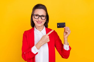 Photo of funny elder brunette lady index card wear spectacles red cardigan isolated on yellow color background clipart