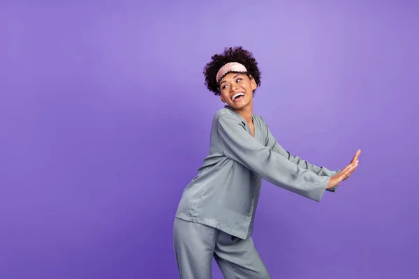 Blog Fényképezés funky beautiful african student grey nightwear smiling dancing looking empty space isolated purple color background — Stock Fotó