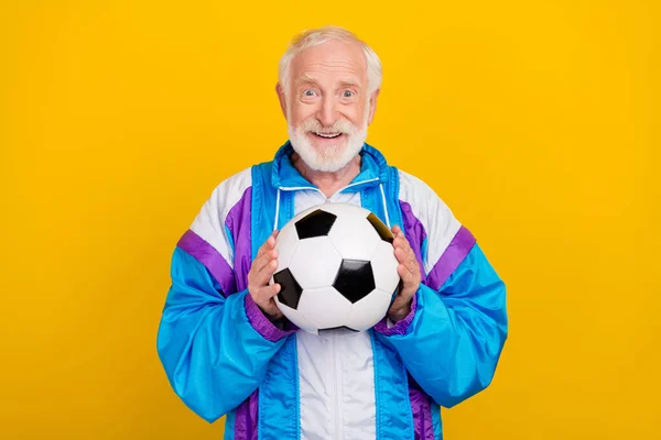 Photo of senior man throw ball gamer player activity wear old-fashioned costume isolated over yellow color background.