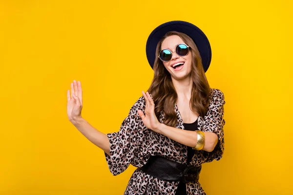 Photo of funky happy attractive young woman cool good mood wear glasses dance isolated on yellow color background — Stock Photo, Image