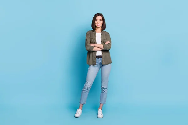 Full body photo of cool satisfied glad lady stand with folded arms wear khaki clothes isolated over sky light color background — Stockfoto