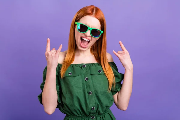 Photo of horned funky young woman dressed off-shoulders blouse dark eyewear showing hard rock sign isolated violet color background — Stock Photo, Image