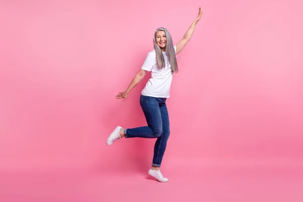 Vista completa del tamaño del cuerpo de la atractiva mujer de pelo gris alegre bailando divirtiéndose aislada sobre fondo de color pastel rosa —  Fotos de Stock
