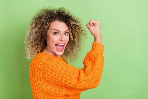 Profile photo of cool millennial blond lady hand fist yell wear orange sweater isolated on green color background — Stock Photo, Image