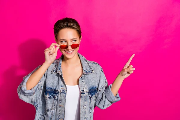Photo of young happy positive attractive woman look point finger empty space enjoy isolated on pink color background — Stock Photo, Image