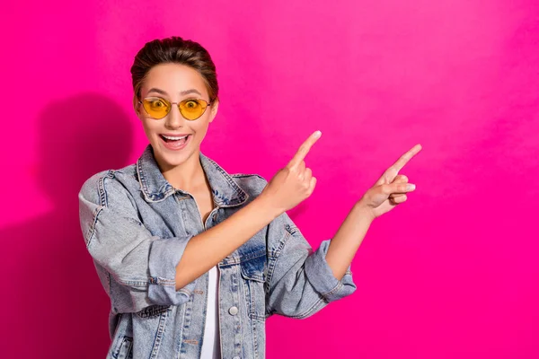 Photo of young amazed shocked woman point finger empty space good mood news isolated on pink color background — Stock Photo, Image