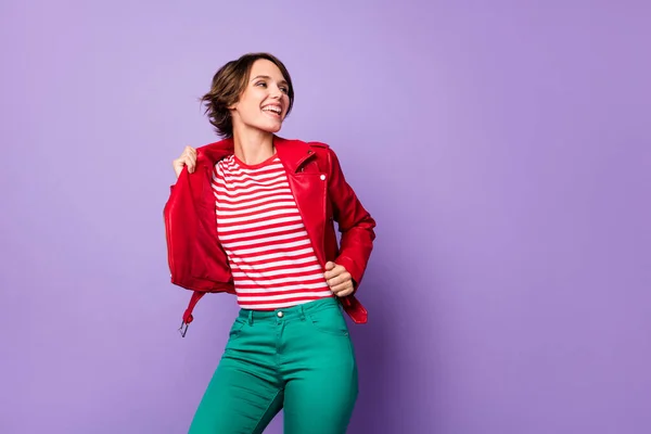 Photo of positive lady arms touch jacket look empty space beaming smile isolated on violet color background — Stock Photo, Image
