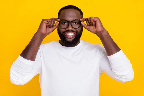 Portret van openhartige tevreden jonge man handen aanraken bril tand glimlach goed humeur geïsoleerd op gele kleur achtergrond — Stockfoto