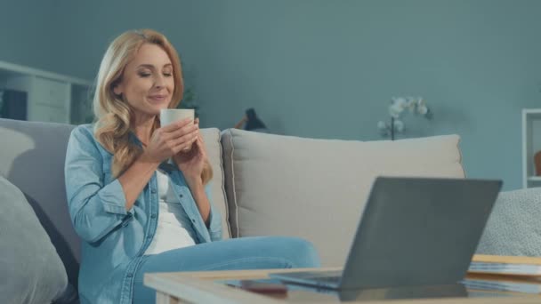 Fredelig avslappet dame sitte sofa nyte morgenkaffe – stockvideo