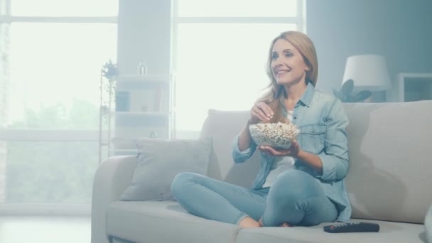 Lovely nice glad amazed lady sit couch eat popcorn watch series — Stock Video