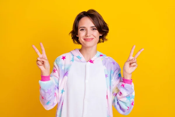 Photo of young attractive girl happy positive smile show peace cool v-sign isolated over yellow color background — Stock Photo, Image