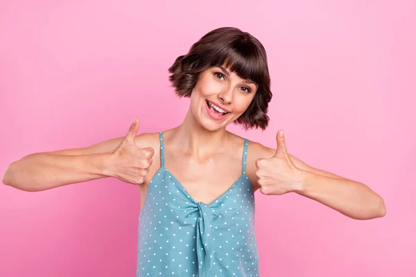 Portrét atraktivní veselá hnědovlasá dívka ukazující dva dvojité palce izolované přes růžové pastelové barvy pozadí — Stock fotografie