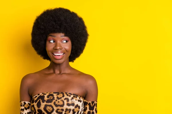 Foto van glanzende opgewonden donkere huid vrouw gekleed luipaard outfit glimlachen op zoek lege ruimte geïsoleerde gele kleur achtergrond — Stockfoto