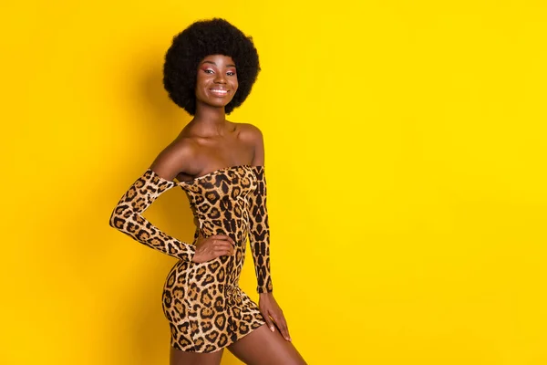 Photo of charming confident dark skin lady wear off-shoulders clothes arm waist empty space smiling isolated yellow color background — Stock Photo, Image
