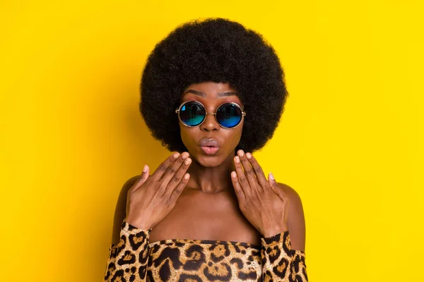 Photo of sweet impressed dark skin woman dressed leopard outfit glasses arms cheeks isolated yellow color background