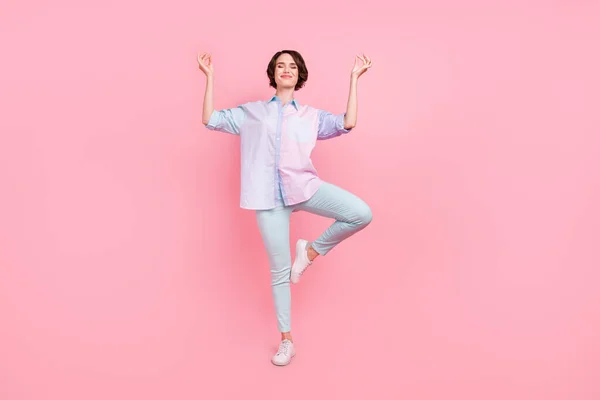 Повна довжина тіла фотографія жінка посміхається практикує йогу в повсякденному одязі ізольовані пастельно-рожевий кольоровий фон — стокове фото