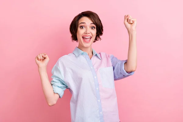 Photo portrait woman happy gesturing like winner isolated pastel pink color background — Stock Photo, Image