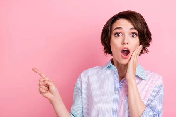 Foto de mujer joven sorprendida dedo de punta impactada espacio vacío anuncian opción aislado sobre fondo de color rosa —  Fotos de Stock