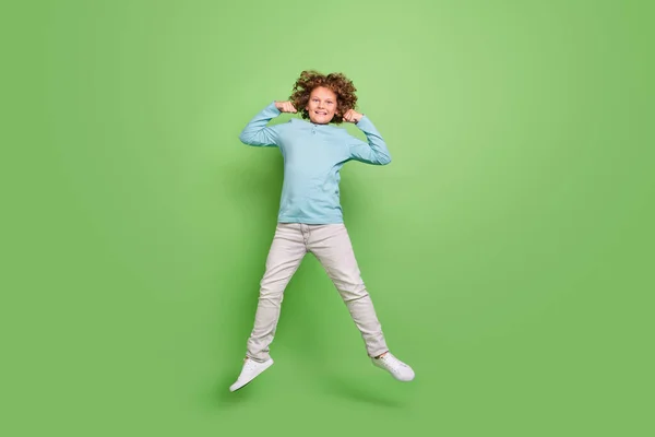 Volledige lichaamsomvang uitzicht van mooie vrolijke kerel springen demonstreren kracht geïsoleerd over helder groene kleur achtergrond — Stockfoto