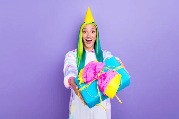 Photo of amazed delivery lady give you present wear cone cap kigurumi costume isolated violet color background — Stock Photo, Image