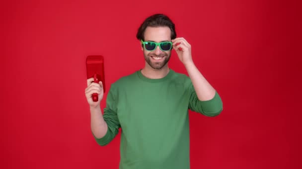Millennial guy shoot air dollars income gun isolated shine color background — Stock Video