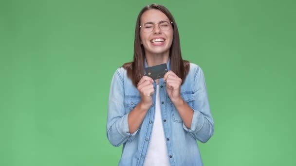 Emocionado lady hold tarjeta ganar lotería millones aislado color verde fondo — Vídeo de stock