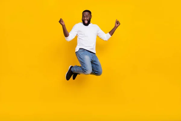 Helkroppsporträtt av glad kille höja nävar fira framgång prestation isolerad på gul färg bakgrund — Stockfoto
