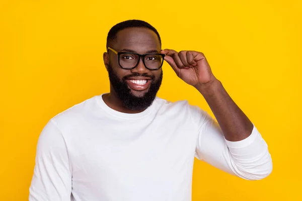 Portrait of candid friendly person hand touch glasses toothy smile look camera isolated on yellow color background — Stock Photo, Image