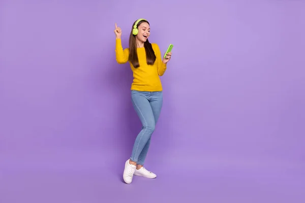 フルボディ写真の若い女の子持っている楽しいダンス楽しむリズムサウンドヘッドフォンモバイル孤立した紫の色の背景 — ストック写真