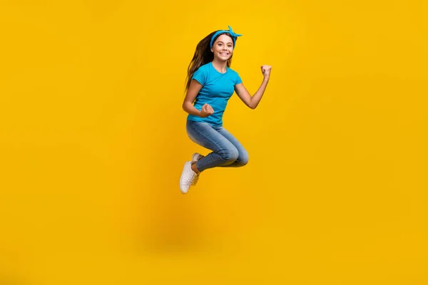 Full body profile side photo of young excited girl jump rejoice victory fists hands awesome isolated over yellow color background — Stock Photo, Image