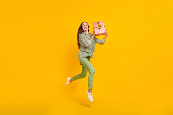 Full body profile side photo of young cheerful girl jumper energetic receive present isolated over yellow color background — Stock Photo, Image