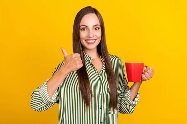 Photo of young pretty woman show thumb-up ads suggest perfect espresso isolated over yellow color background — Stock Photo, Image