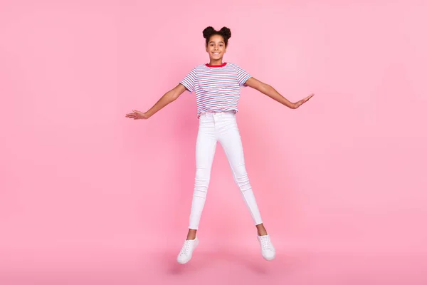 Full body photo of brown bun haired stylish trendy african american girl wear casual outfit jump isolated on pink color background — Stock Photo, Image