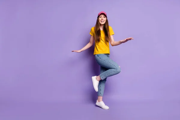 Pełna długość zdjęcie szczęśliwej młodej kobiety nosić dżinsy nakrycia głowy styl ulicy izolowane na fioletowym tle koloru — Zdjęcie stockowe