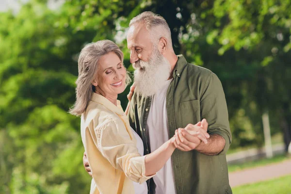 Foto de perfil de expresión divertida pelo gris retirado pareja danza usar camisas al aire libre caminar en el parque —  Fotos de Stock