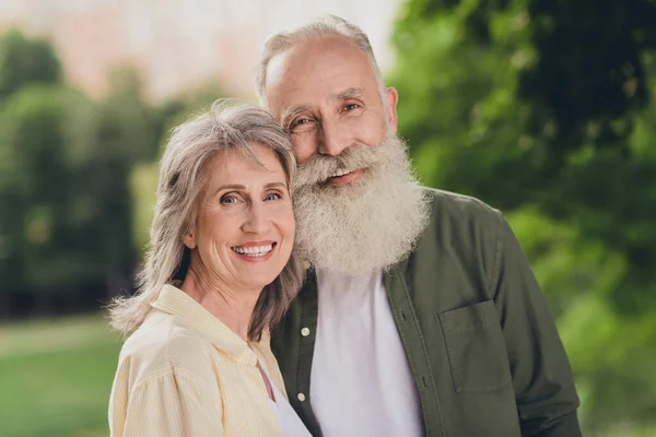 Фото веселой позитивной пенсионерки пара обнимашки сияющие улыбки носить повседневный наряд природный парк сад на открытом воздухе — стоковое фото
