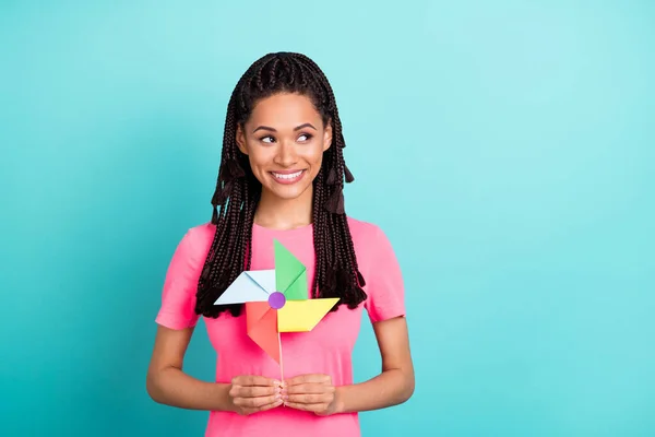 Photo of lovely brunette hairdo young lady hold toy look empty space wear pink t-shirt isolated on teal color background — Stock Photo, Image