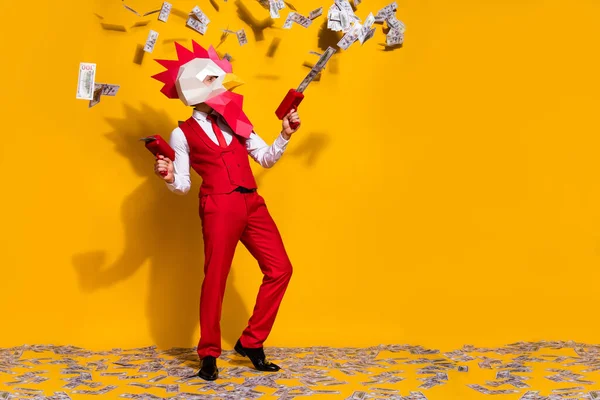 Photo of incognito wacky guy hold usd dropper gun wear cock mask red suit isolated yellow color background — Stock Photo, Image